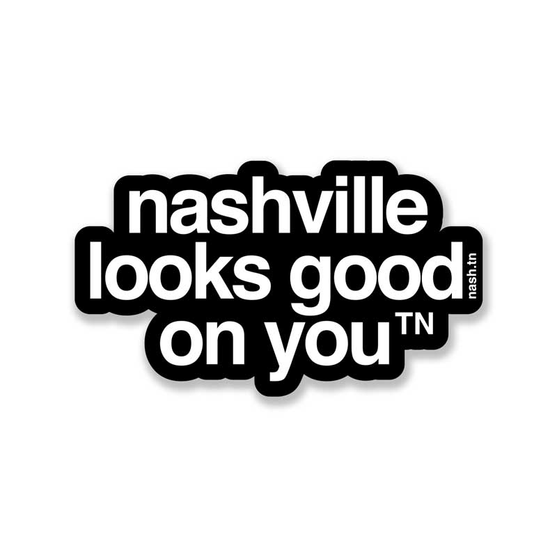 Black sticker with white letters on a white background, the sticker shape is cut around the letters. The sticker says nashville looks good on youᵀᴺ  with a small, superscript TN next to the letter u in you. TN is the abbreviation for Tennessee. Nashville is the capital city in Tennessee. 
