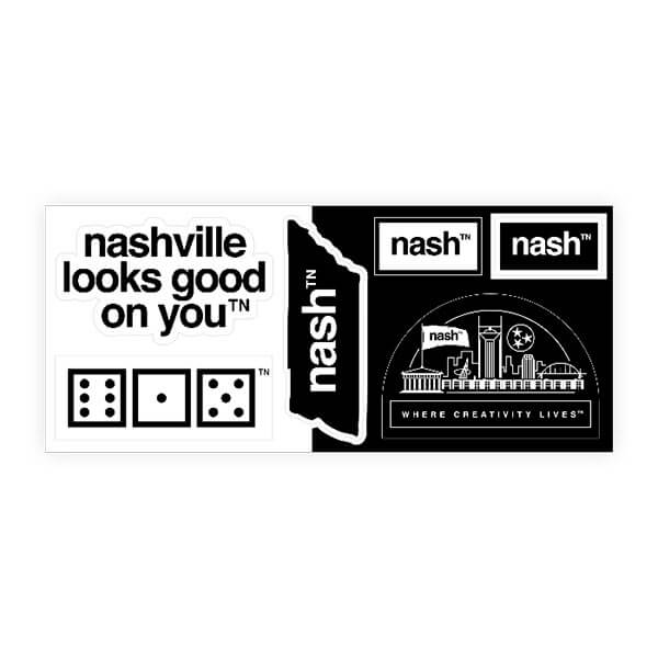Rectangle sheet of stickers on a white background. The left half of the rectangle is white, the right half of the rectangle is black. There are six stickers in different designs scattered across the rectangle. The six stickers are: nashville looks good on youᵀᴺ, where creativity livesᵀᴺ, a TN shaped sticker, nashᵀᴺ in white text, nashᵀᴺ  in black text and 615 dice