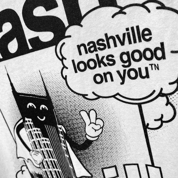 Closeup of black and white artwork showing Nashville's Batman building as a super hero giving the "peace sign" next to a cloud that says nashville looks good on youᵀᴺ  
