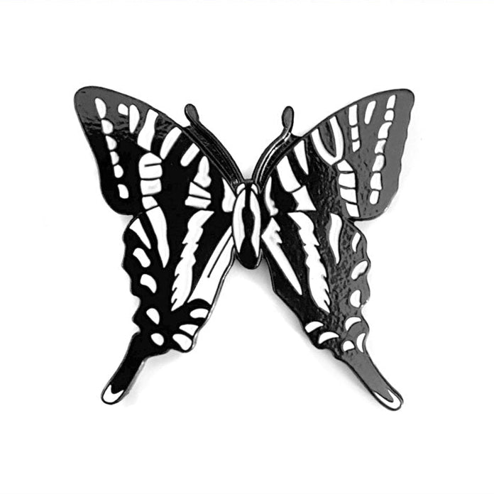 Black and white butterfly-shaped nashville lapel pin on a white background