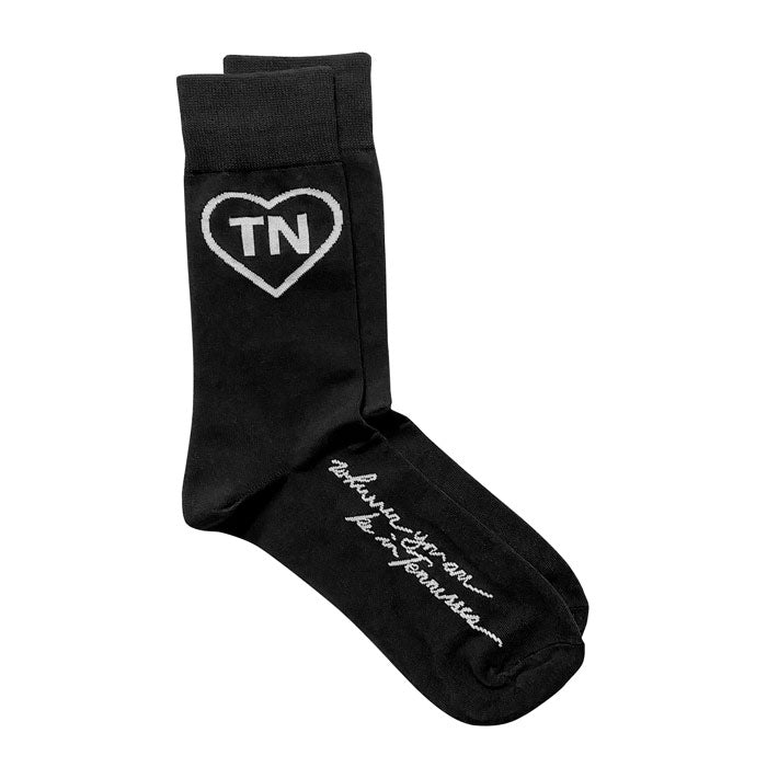 Black socks with a white outline heart and white letters TN inside the heart on a white background. White cursive words "wherever you are be in Tennessee" printed on the arch. TN is the abbreviation for Tennessee.