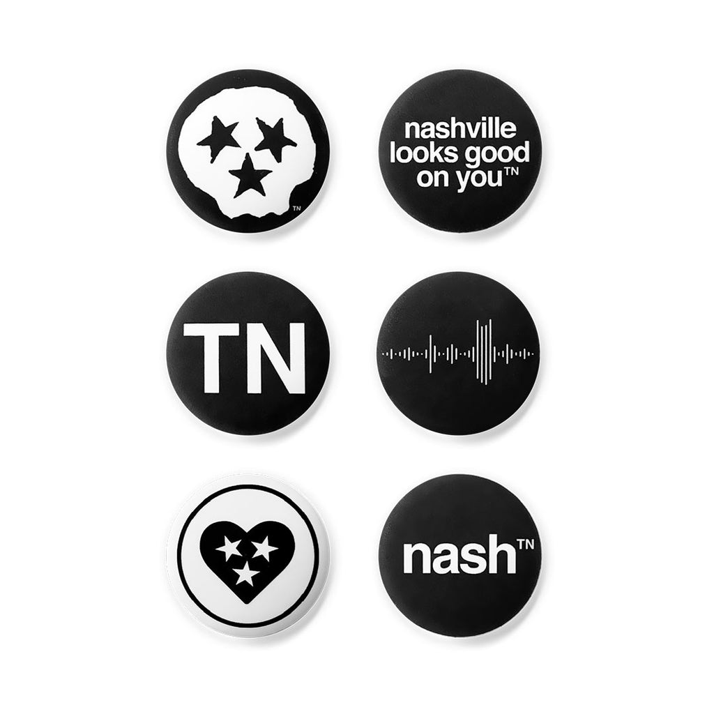 Six, round lapel pin buttons on white background. There are three rows of two pins, each pin has a different design that pays homage to Tennessee.