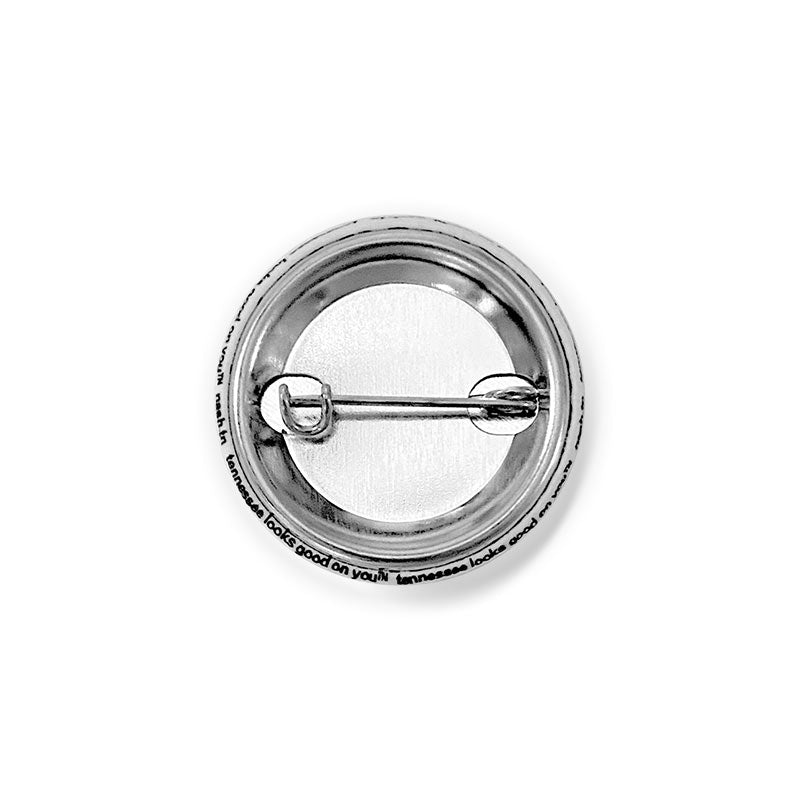 Backside of the round, lapel pin showing the metal post and clasp.