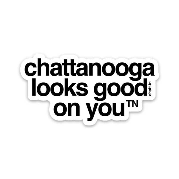 White sticker with black letters on a white background, the sticker shape is cut around the letters. The sticker says chattanooga looks good on you with a small, superscript TN next to the letter u in you. TN is the abbreviation for Tennessee. Chattanooga is a city in Tennessee.