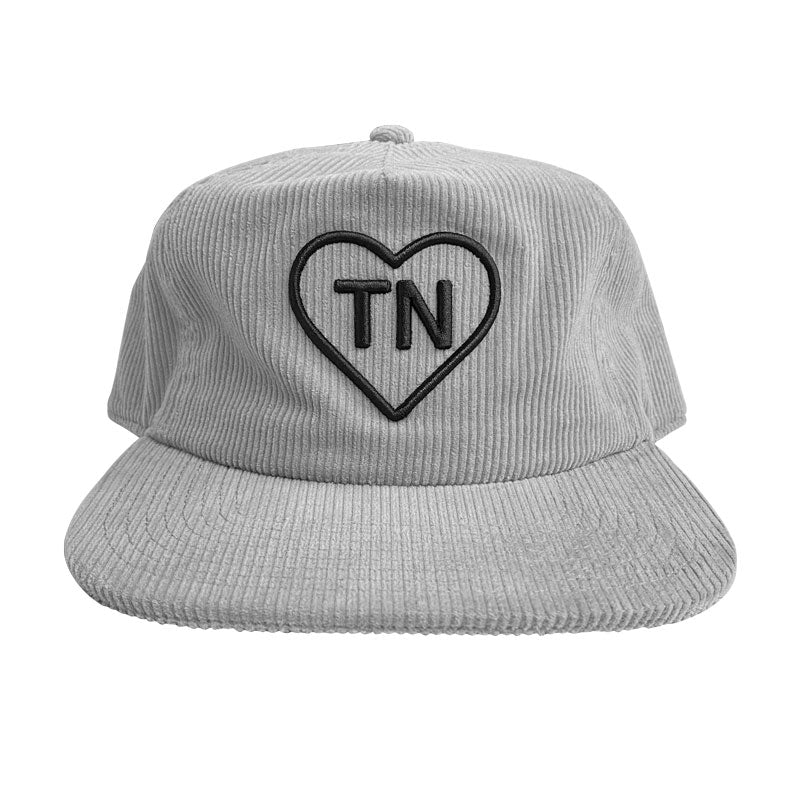 A gray corduroy baseball cap on a white background. The cap has a black outlined heart with the letters TN inside of the heart. TN is the abbreviation of Tennessee.