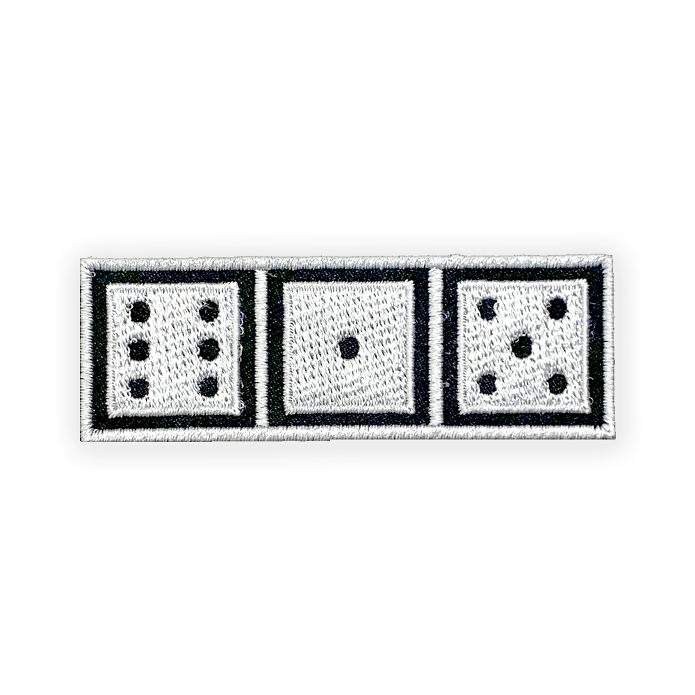 A closeup look at the 615 dice patch. Black, horizontal rectangle patch outlined in white.The rectangle has three, white game dice showing the numbers six, one, and five. 615 is the telephone area code for Nashville, Tennessee.