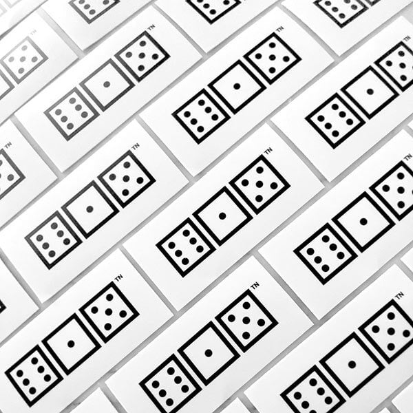 Rows of 615 dice stickers at and angle. Black squares and dots on a white background.