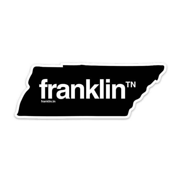 Black sticker on a white background. The sticker is shaped like the state of Tennessee and outlined in white. franklinᵀᴺ is printed in the center of the shape in white. Franklin is a prominent city in Tennessee.
