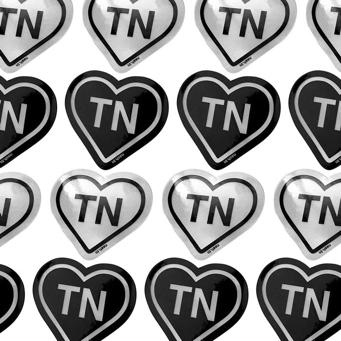 Rows of black and silver holograph heart TN stickers on white background.