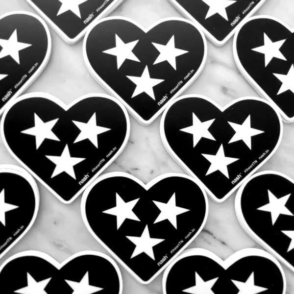 Rows of black heart shaped stickers on a marbled background. The black hearts are outlined in white and have three white hearts in the center. Tennessee is known as the Tri-star state for it's three grand divisions: East, Middle and West.