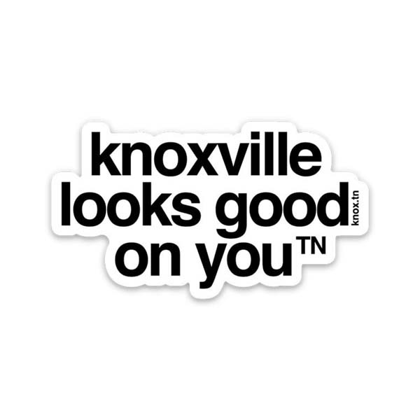 White sticker with black letters on a white background, the sticker shape is cut around the letters. The sticker says knoxville looks good on you with a small, superscript TN next to the letter u in you. TN is the abbreviation for Tennessee. Knoxville is a city in Tennessee.