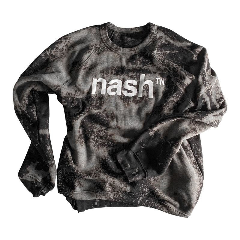 Crew sweatshirt with nashᵀᴺ  logo printed in white. The sweatshirt has been dyed and bleached to have to have a marbled appearance with grays, browns and blues
