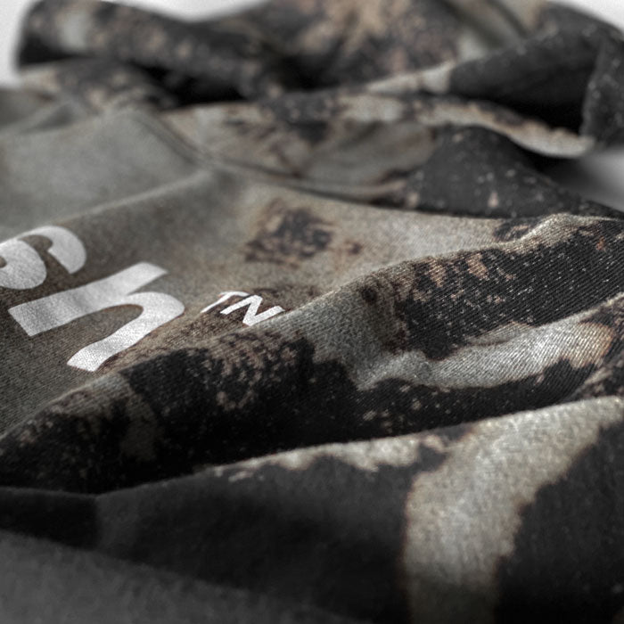 Closeup look at the fabric texture and dye pattern on the reverse dyed hooded sweatshirt. 