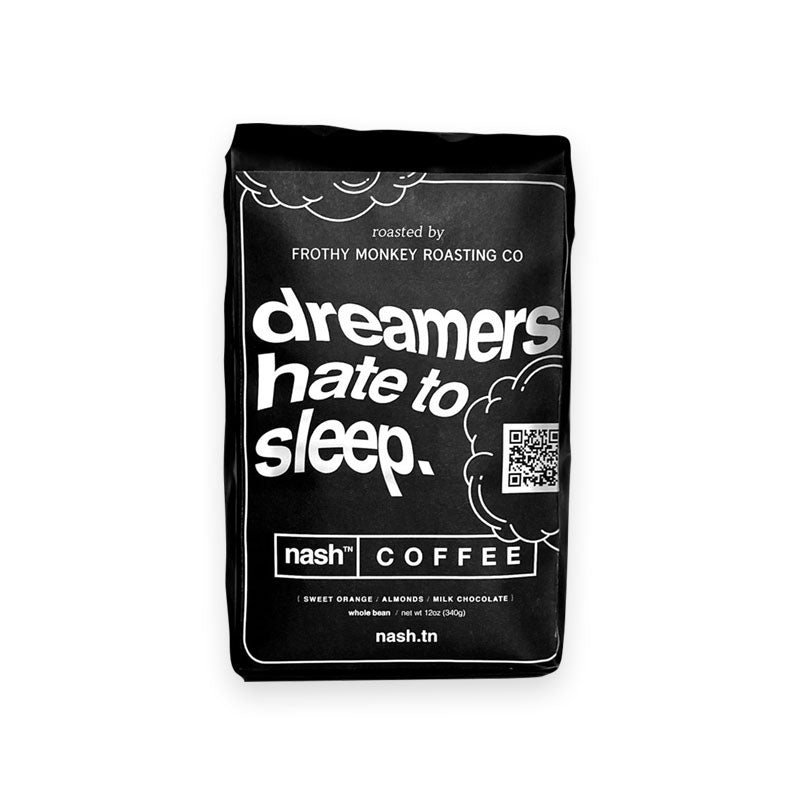 Black coffee bag on white background. The bag label has white text and cloud shape outlines. The text is wavy and says dreamers hate to sleep. 