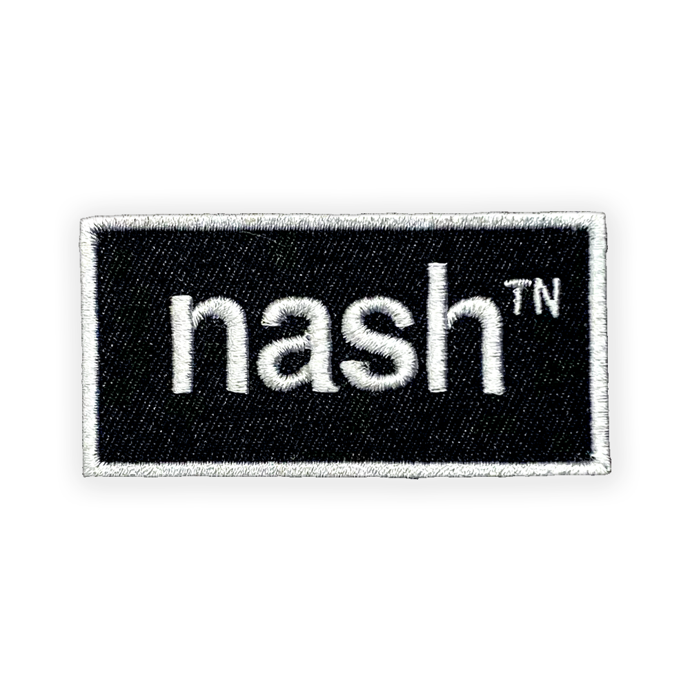 Close up look at a black rectangle outlined in white. The white nashᵀᴺ logo is centered inside the rectangle.
