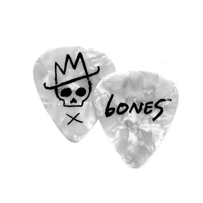 Front and backside of white pearlized guitar pick on white background.  There is a skull with X and cowboy hat on the left guitar pick and the right pick has 6ONE5 on it 6ONE5 looks like the word bones. 615 is the telephone area code for Nashville, Tennessee