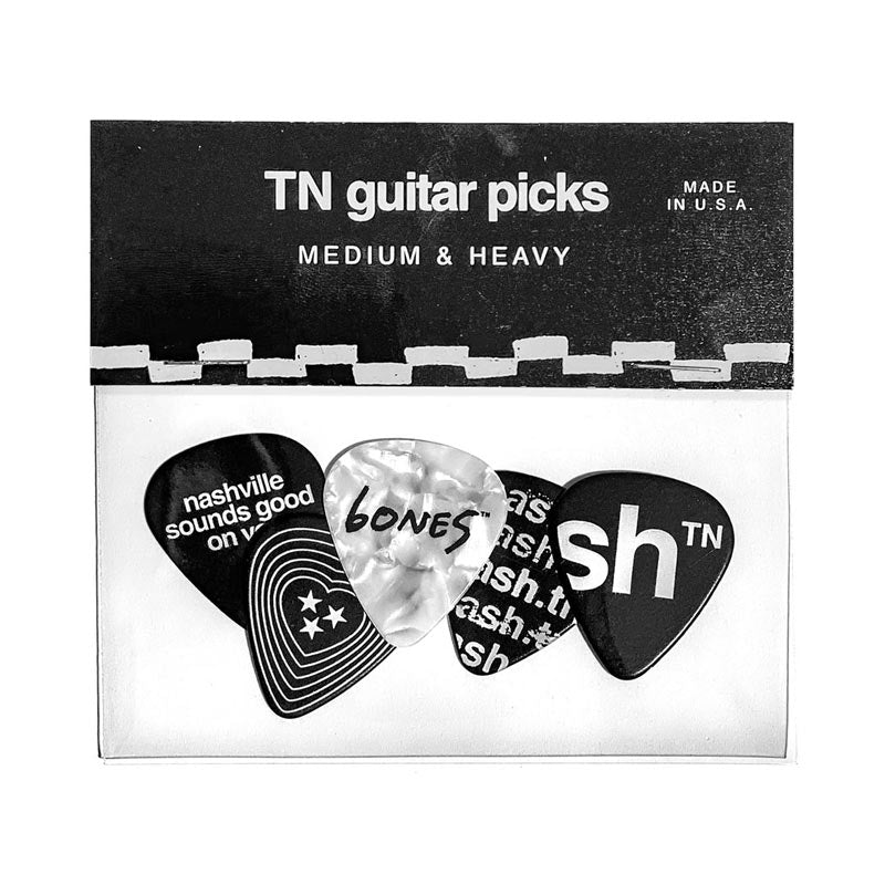 Back side of guitar pick package. There are five guitar picks, each with a different Nashville-related design.