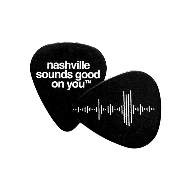 Front and back side of a black guitar pick on a white background. Wav audio file styled into Nashville skyline on one side and  nashville sounds good on youᵀᴺ on the other side. 