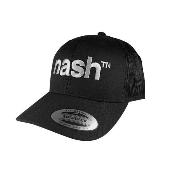 Black baseball cap on white background. The hat is angled to the left and has a slightly curved visor with a horzontal oval sticker that says SNAPBACK. The cap has a white embroidered nashᵀᴺ  logo on the front.