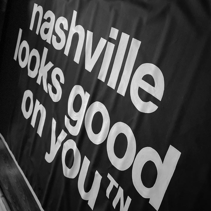 White text on black background reads, at and angle, nashville looks good on youᵀᴺ  