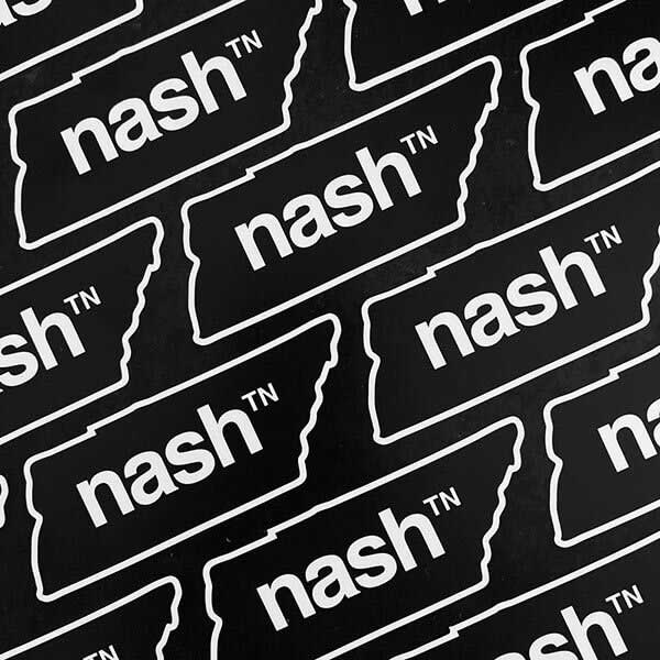 Rows of nashᵀᴺ  stickers on a black background. The stickers are shaped like the state of Tennessee and have a white outline and white text. The logo is printed in the center of the shape.